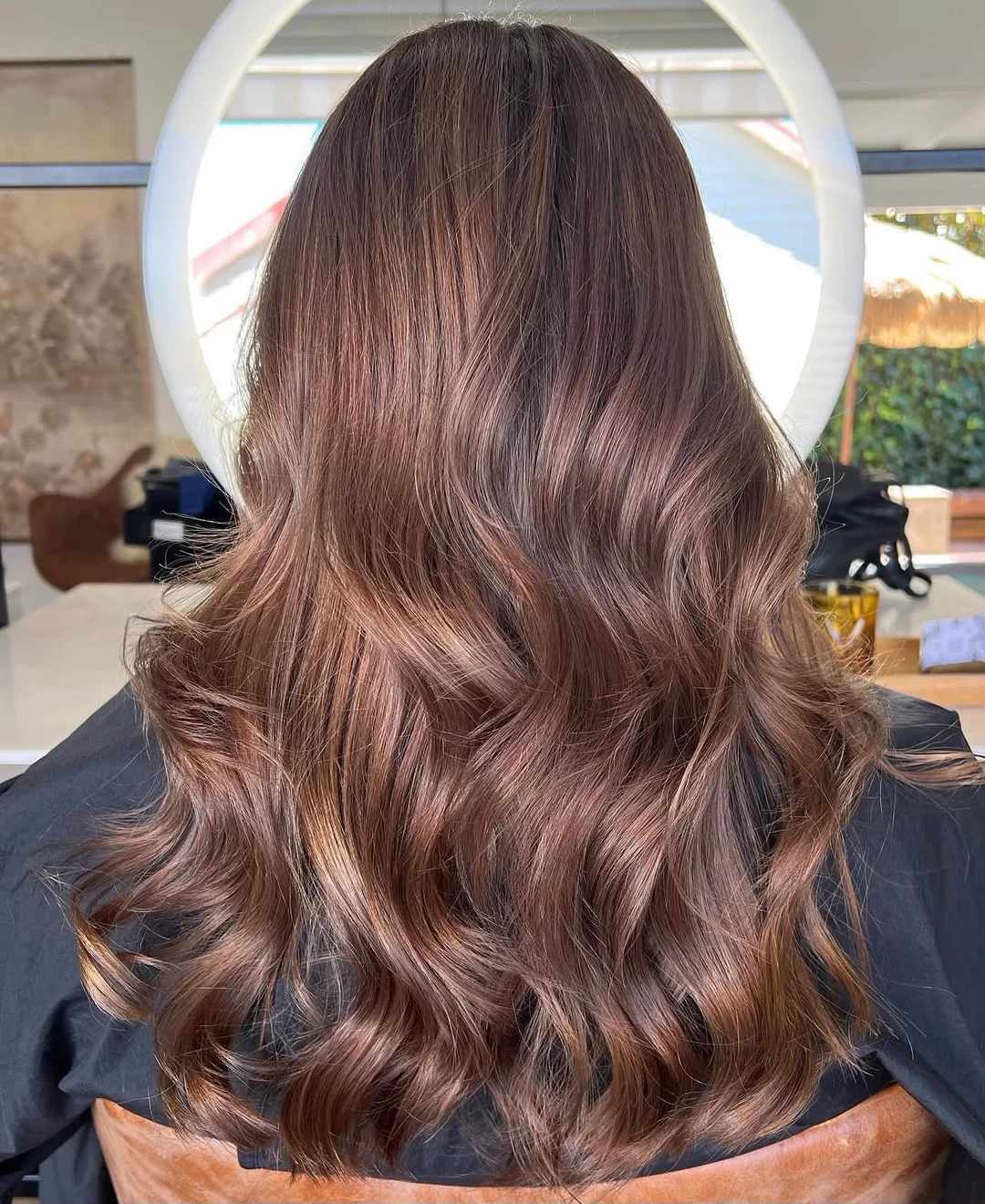 Glossy brunette hair after a smoothing service